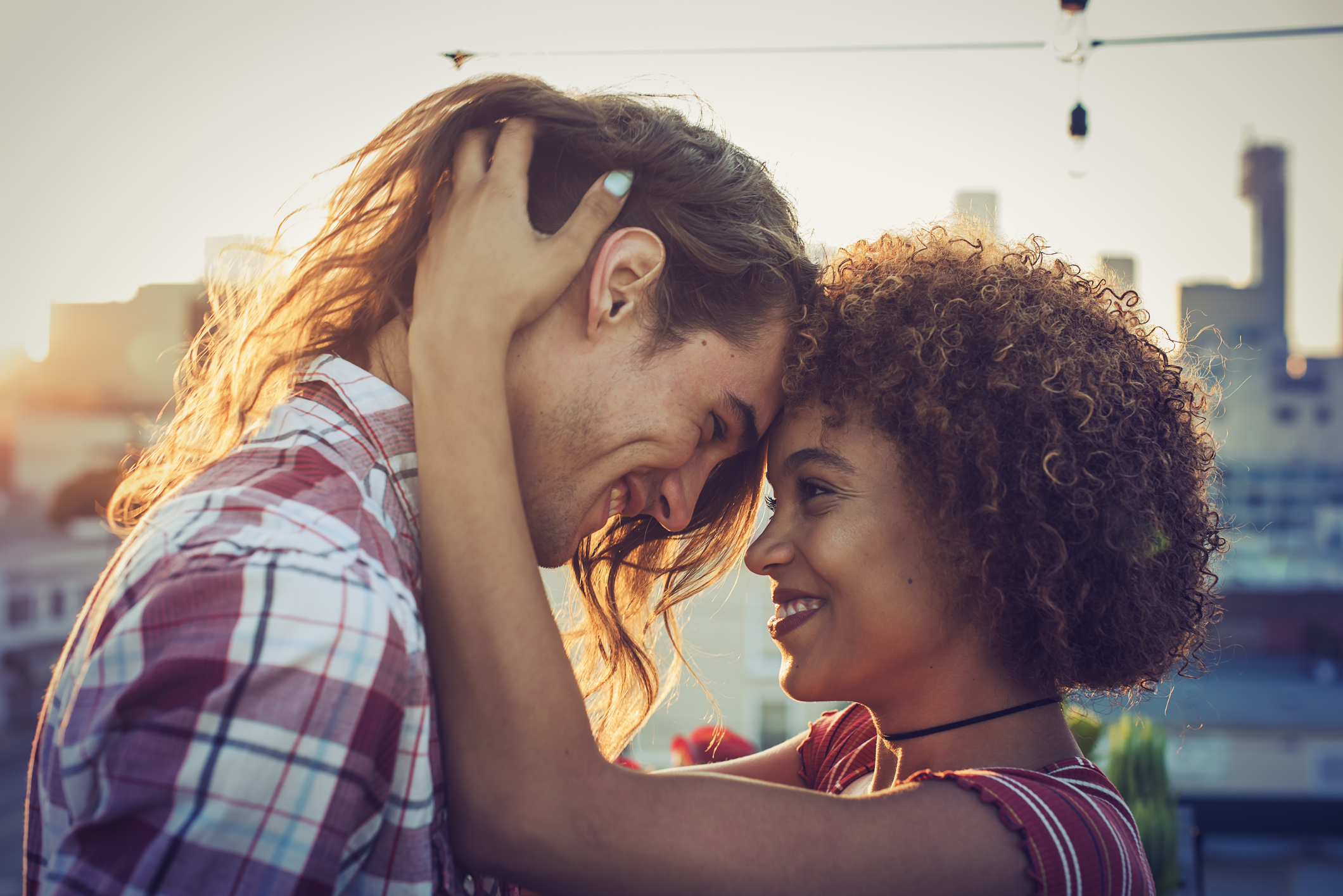 Couple embracing on urban rooftop