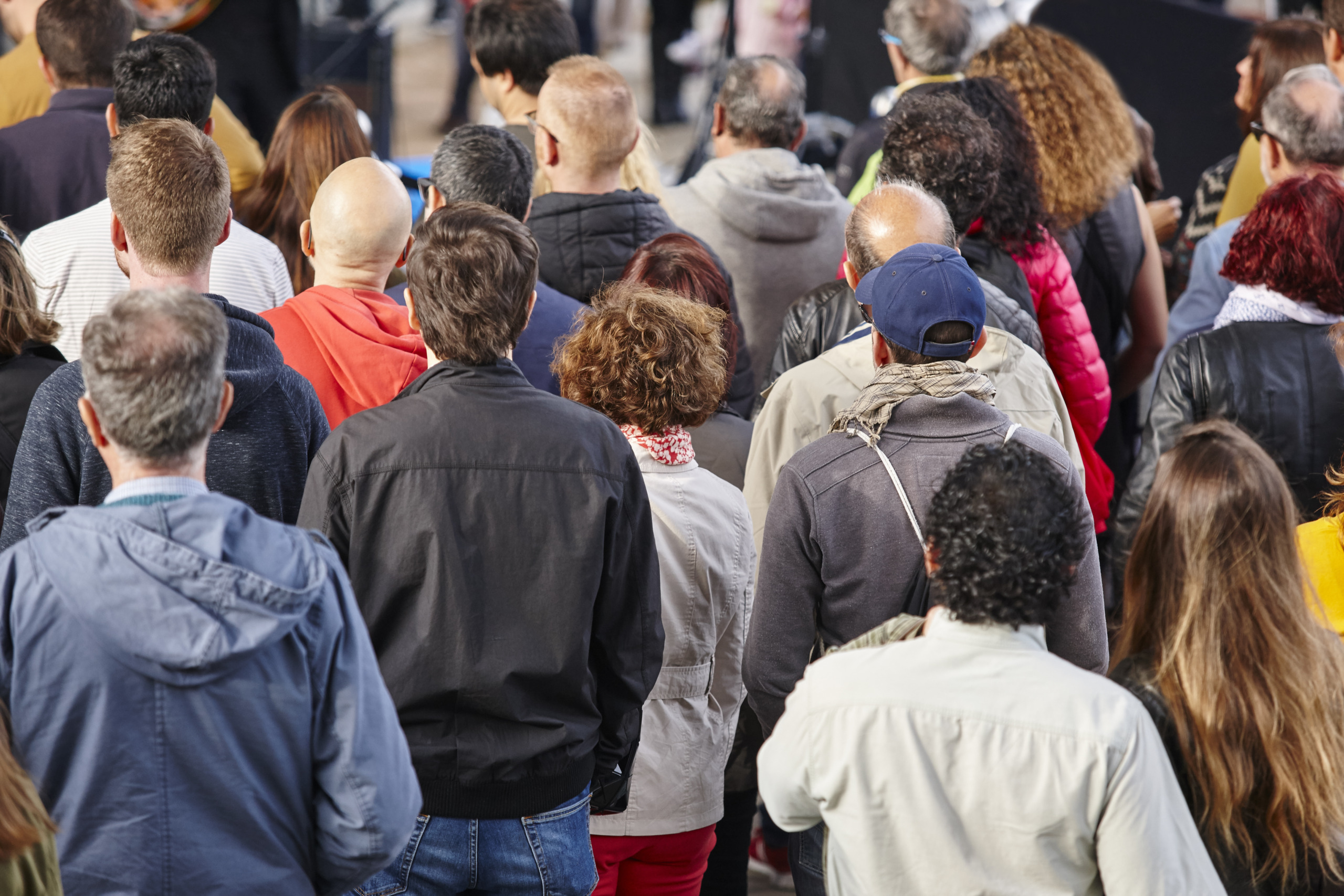 Group of people listening on the street. Crowded background