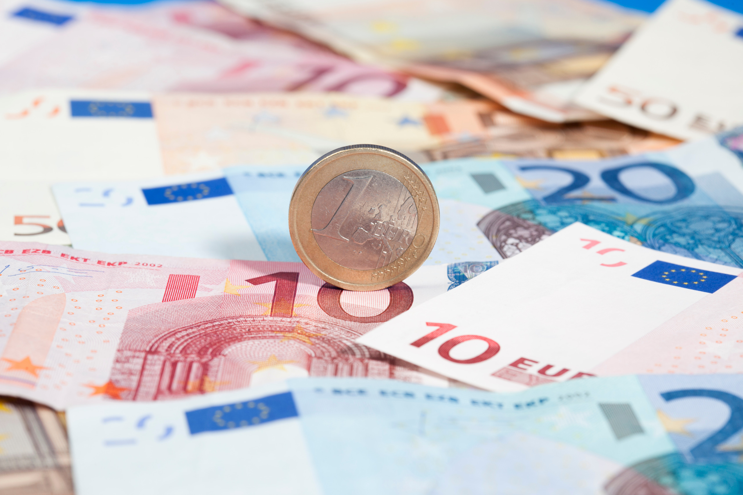 Close-Up Of Euro Notes And Coin