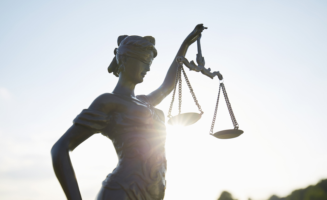Lady Justice against clear sky