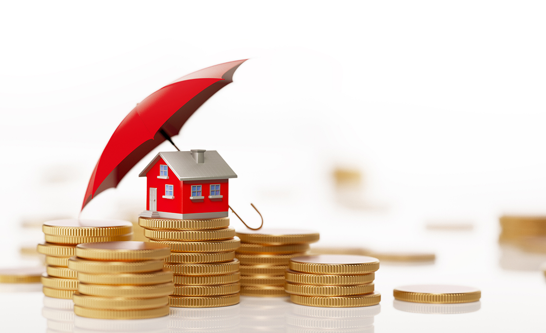 Red Toy House Sitting On White Background Behind Coin Stack: Insurance And Real Estate Concept