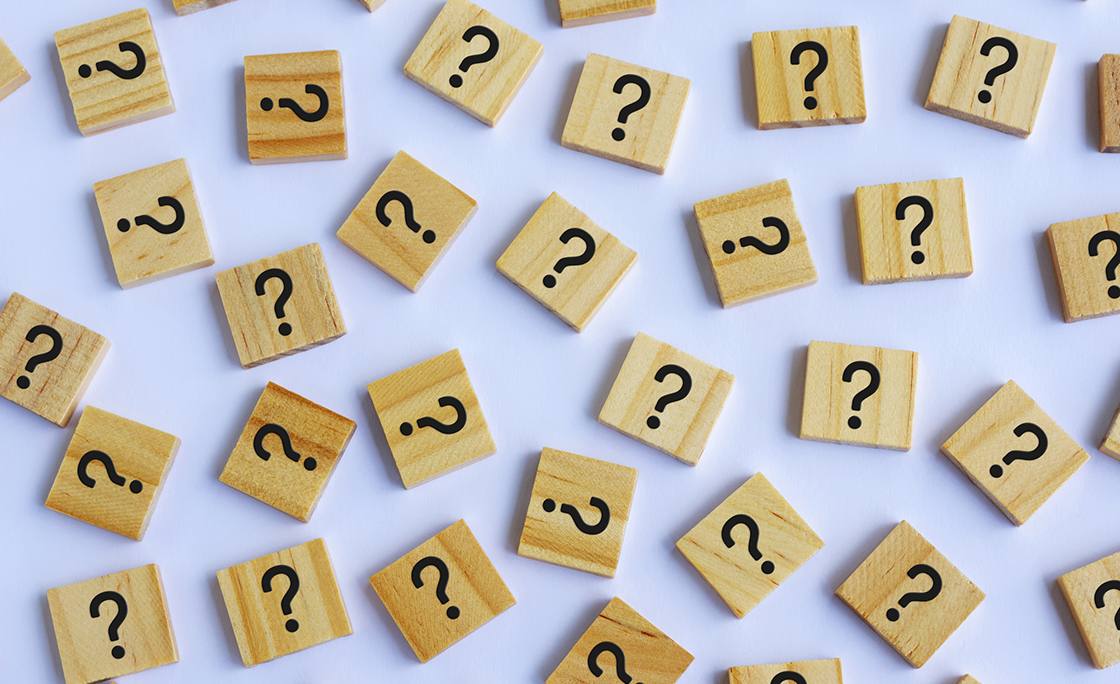 Question Marks on Wooden Block White Background