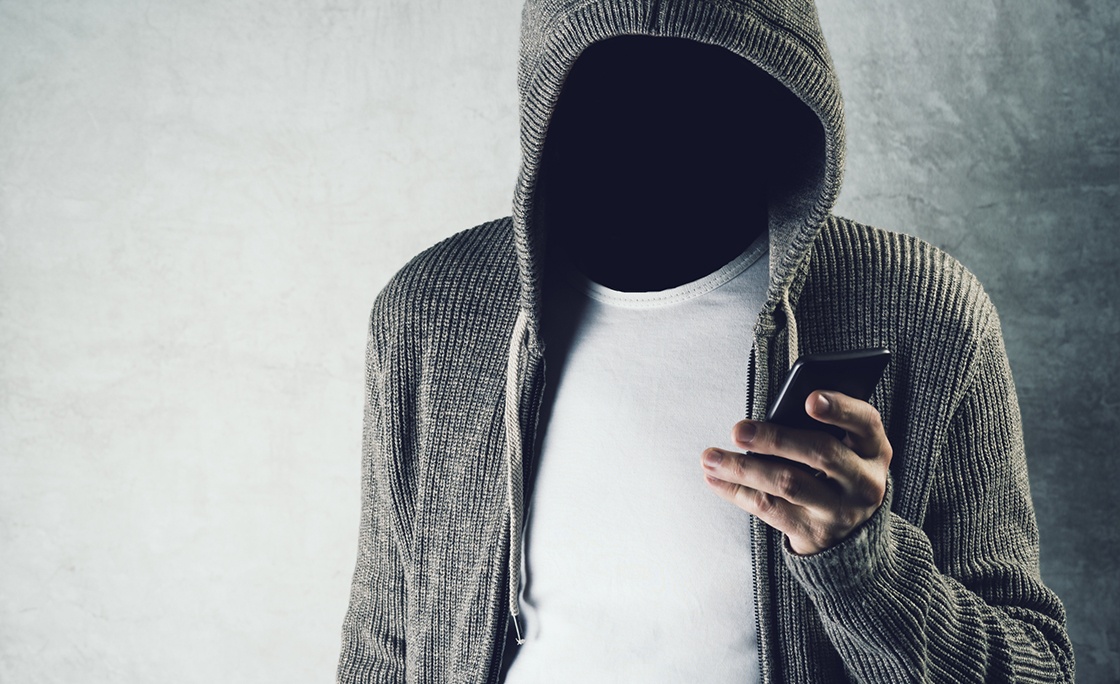 Digital Composite Image Of Faceless Man Using Smart Phone Against Wall