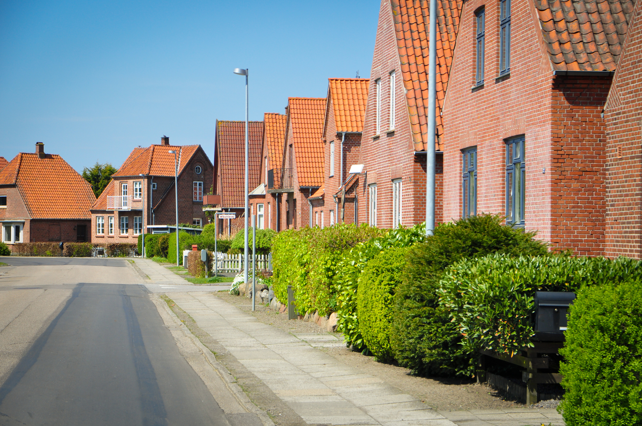 Red brick houses. Street in the little town Nakskov on Lolland. Nice weather with blue sky.