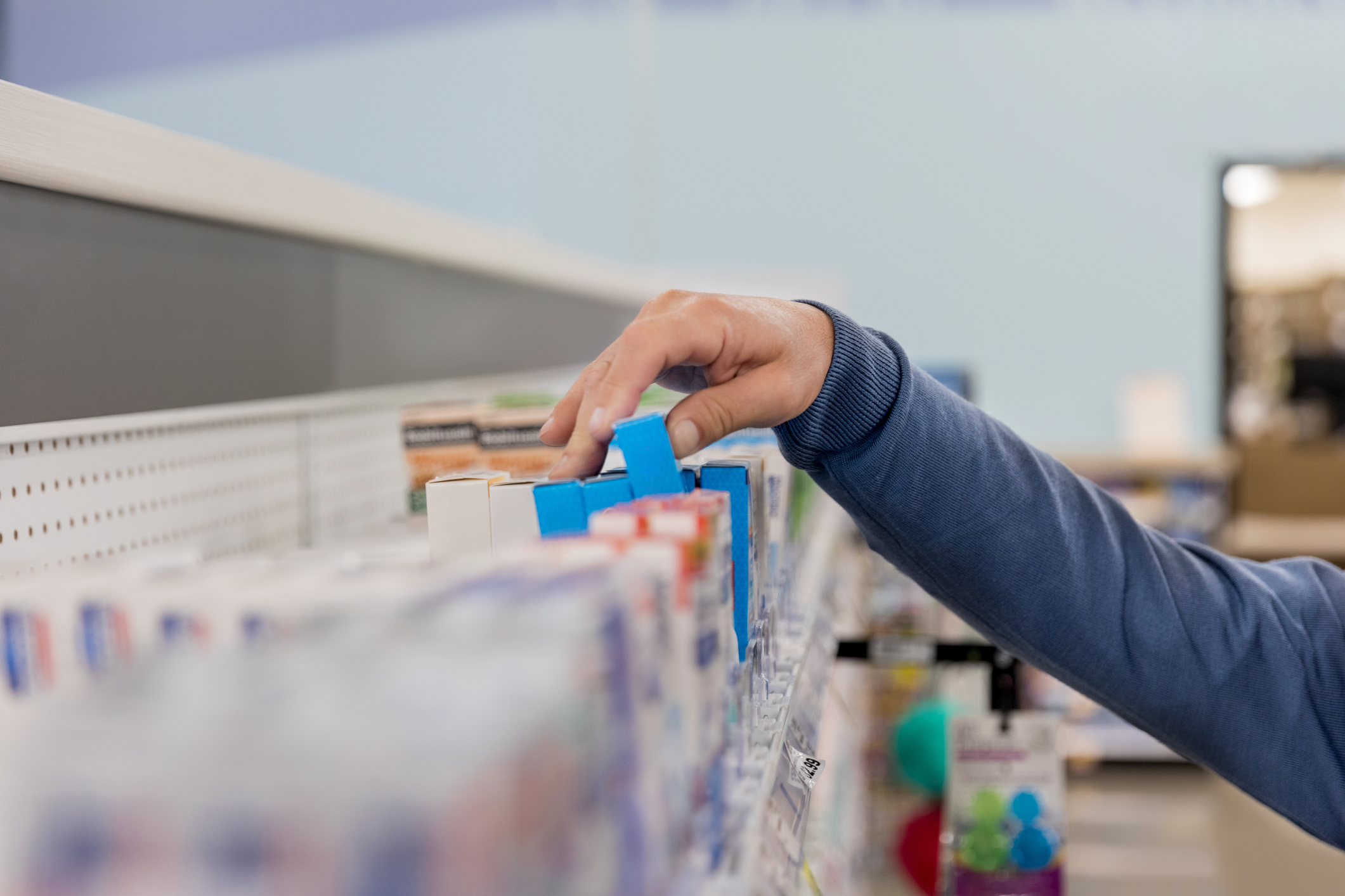 Unrecognizable man chooses box of medication