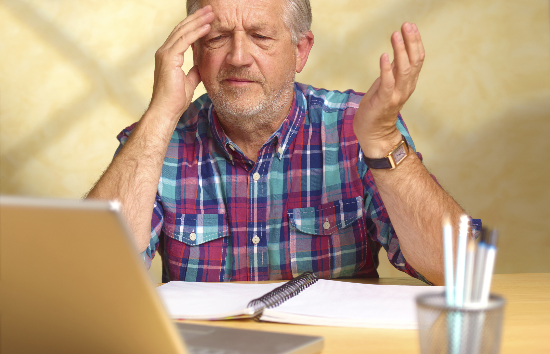 Senior man frustrated by computer