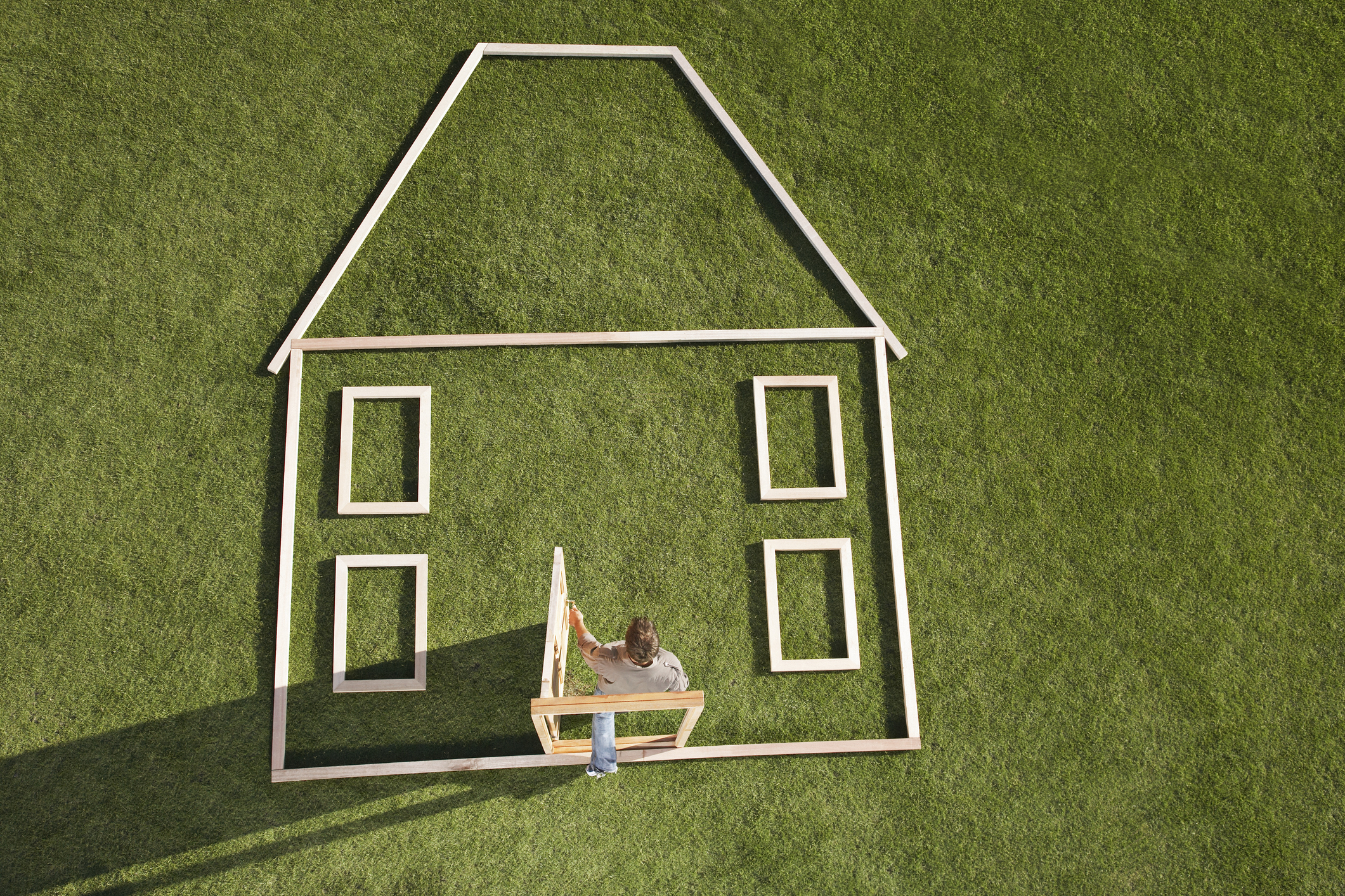 Man walking through door in house outline