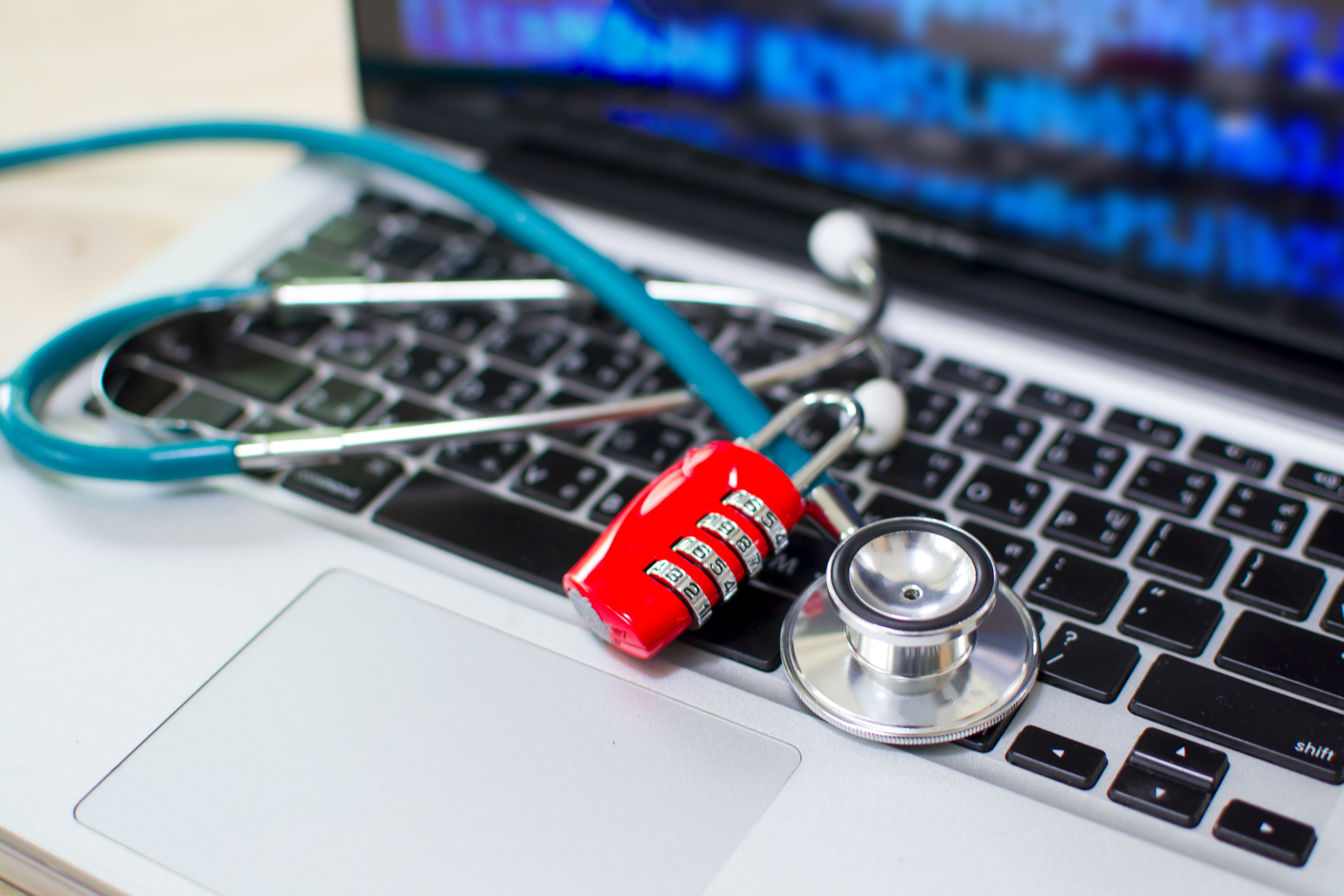 Computer or data analysis – Stethoscope over a laptop computer keyboard toned in blue
