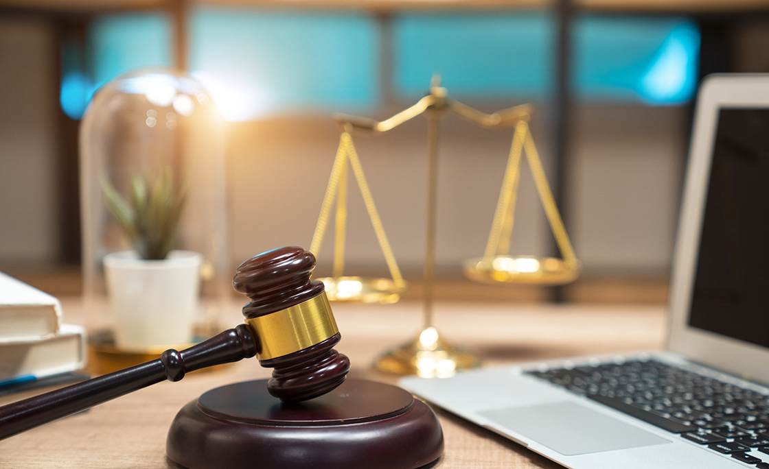 justice and law concept.Lawyer workplace with laptop and documents with dark wooden