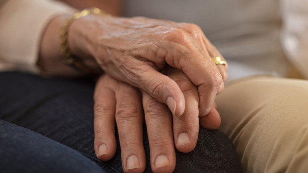Senior couple holding hands