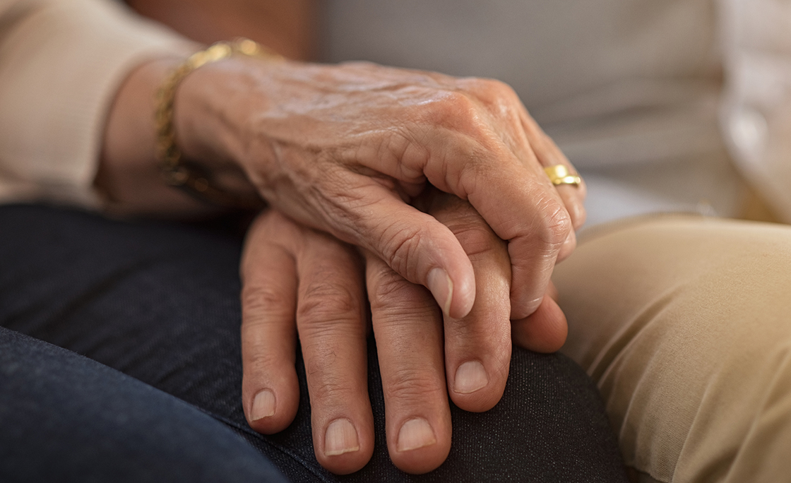 Senior couple holding hands
