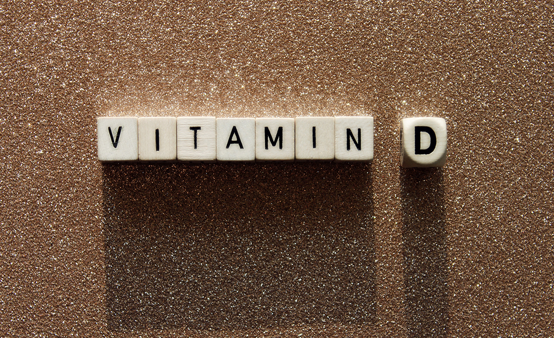 Directly Above View Of Vitamin D Text On Blocks Over Footpath