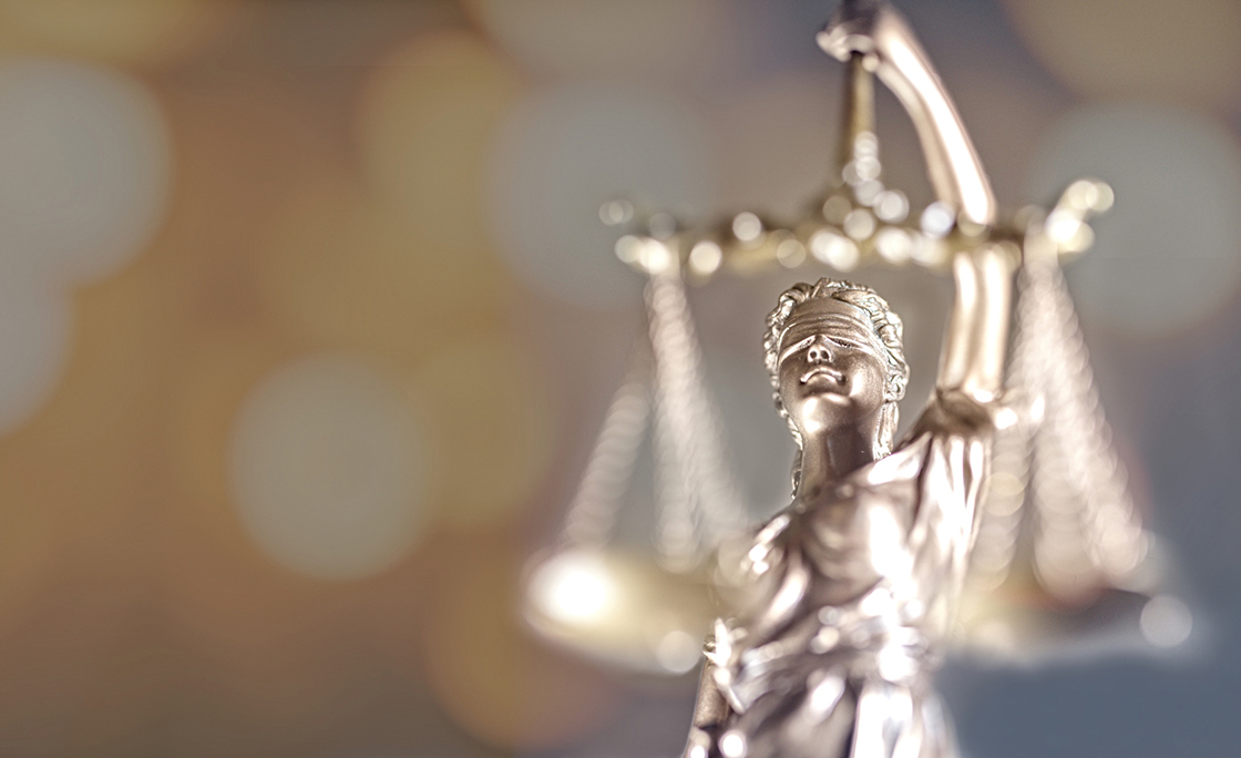 Lady Of Justice Against Illuminated Lights