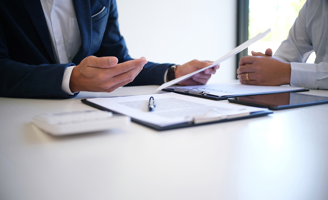 Cropped Image Of Insurance Agent Discussing With Client At Desk
