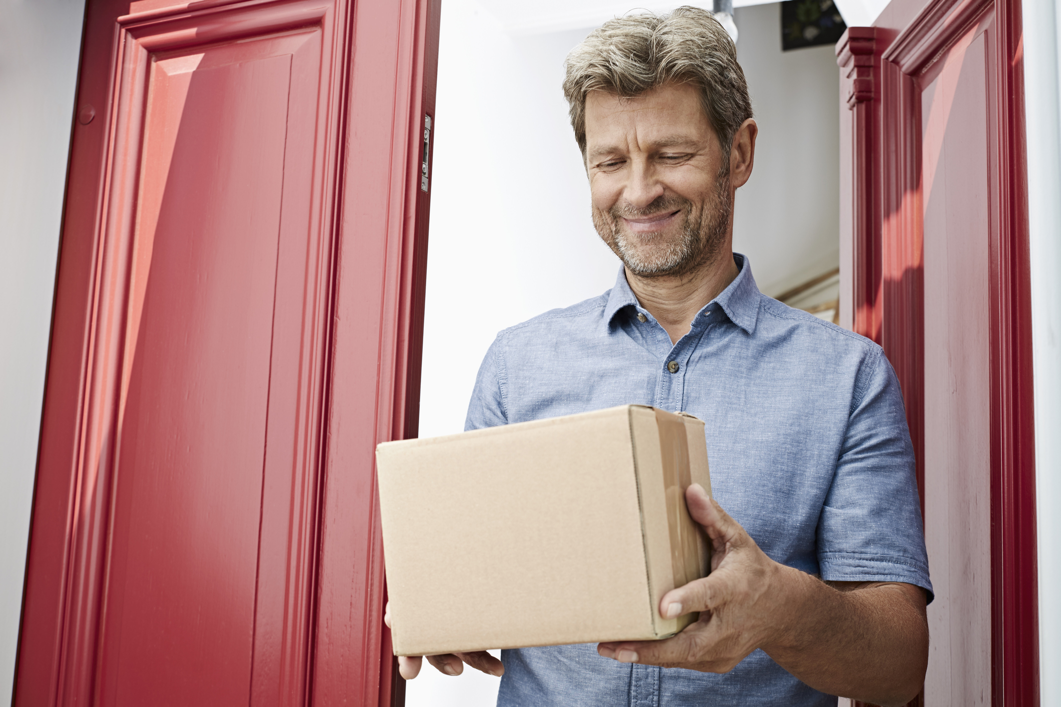Mature man receiving a package at his door