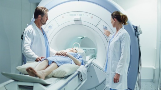 Male and female doctors preparing patient for CAT scan in hospital