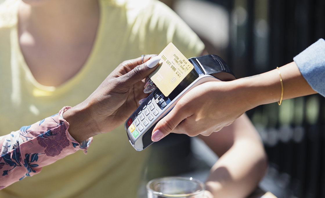 Woman paying waitress with smart card