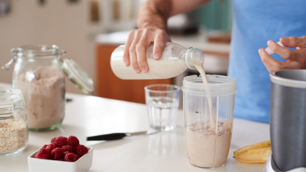 Close Up Of Man Making Protein Shake After Exercise At Home