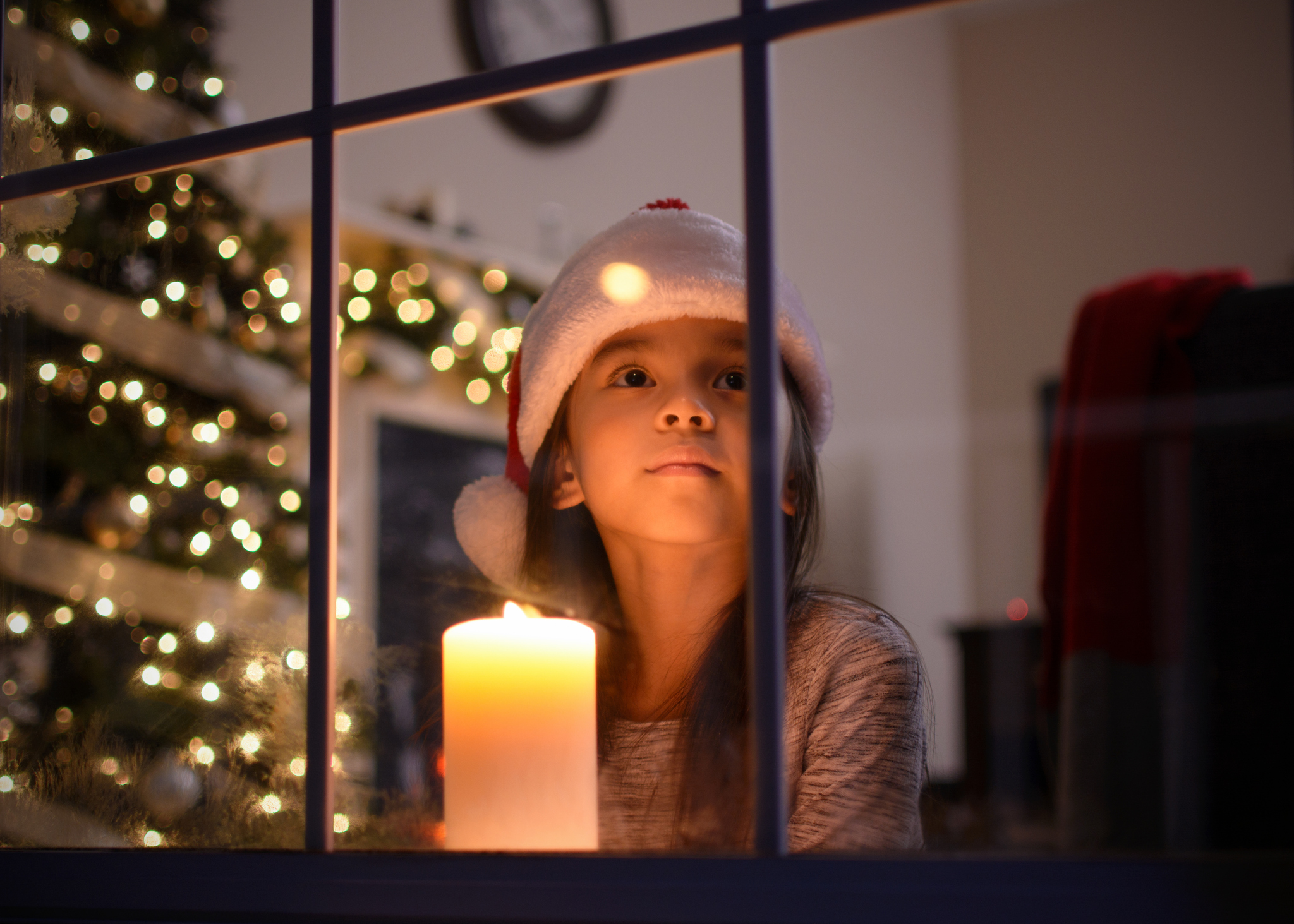 Little girl looking out the window on Christmas