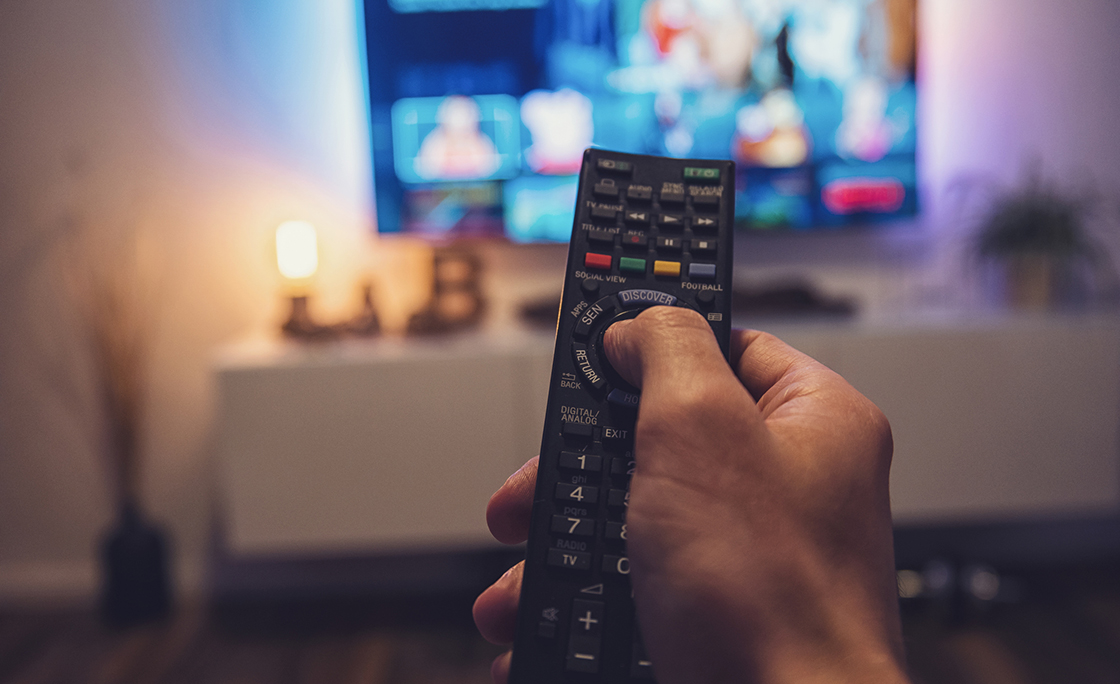 Close-Up Of Hand Holding Television Remote Control