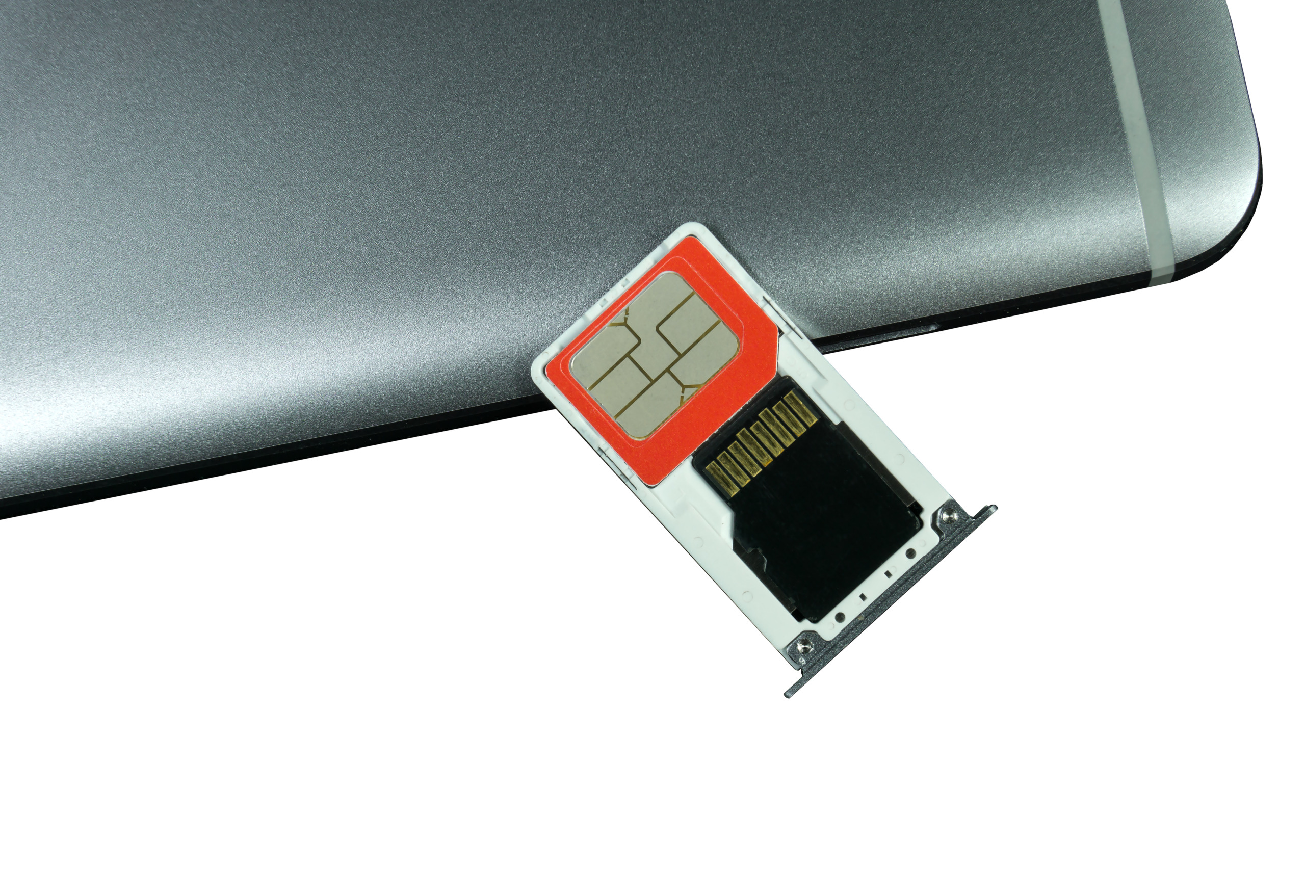 Close-Up Of Sim Card And Mobile Phone Over White Background