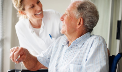 Elderly man speaking to a nurse