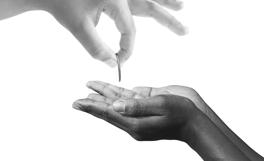 hand gives money to the poor.