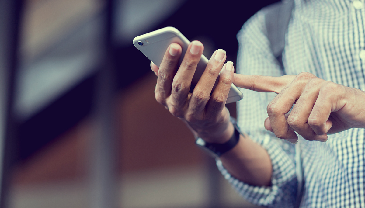 close up traveler backpacker man hand holding smartphone for checking flight online or search information on browser website about plan trip at destination , lifestyle concept
