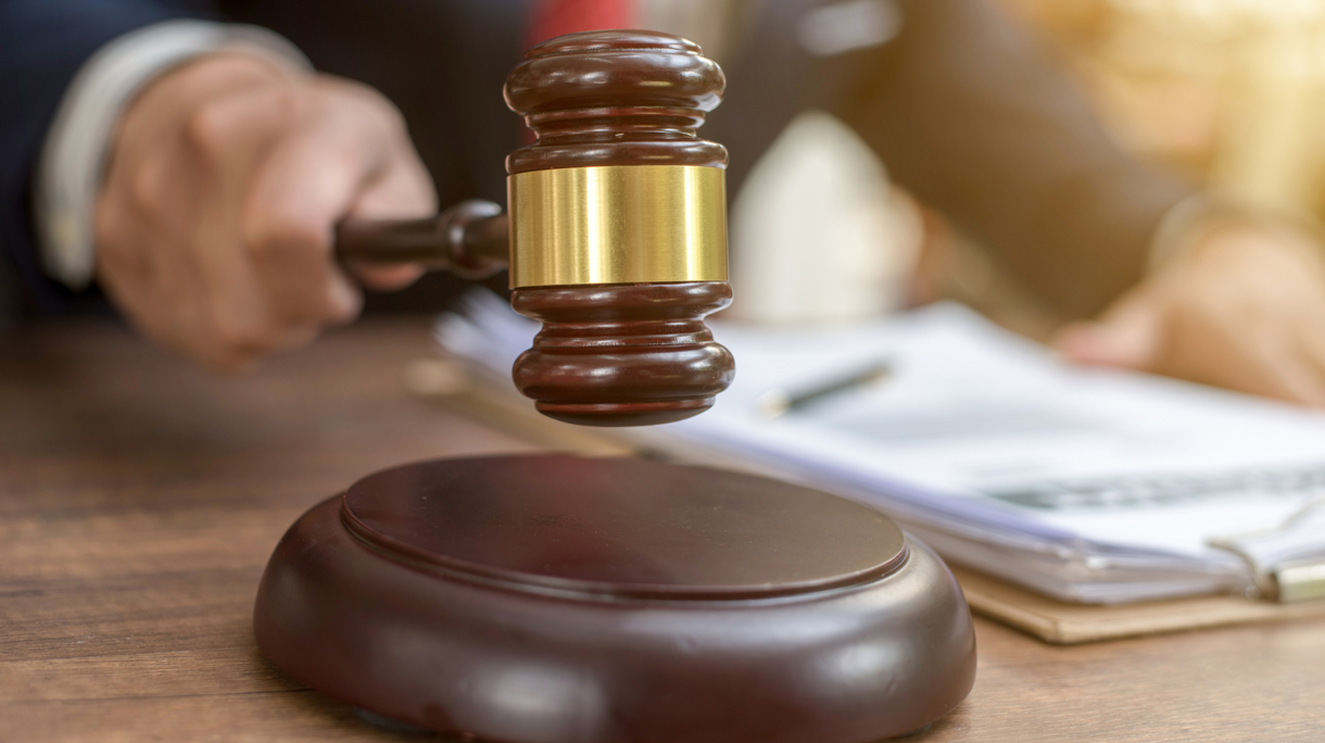 Close up lawyer businessman working or reading lawbook in office workplace for consultant lawyer concept.