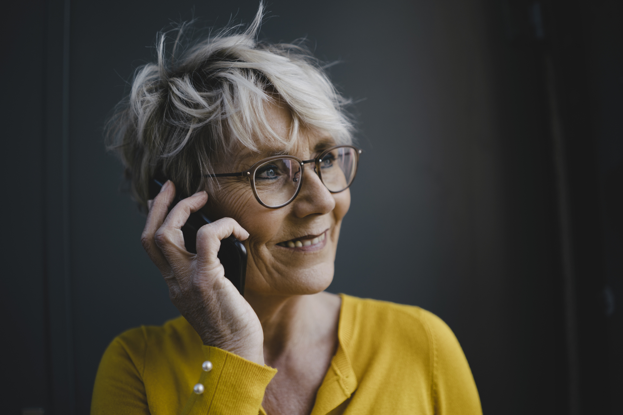 Portrait of mature businesswoman with grey hair on the phone