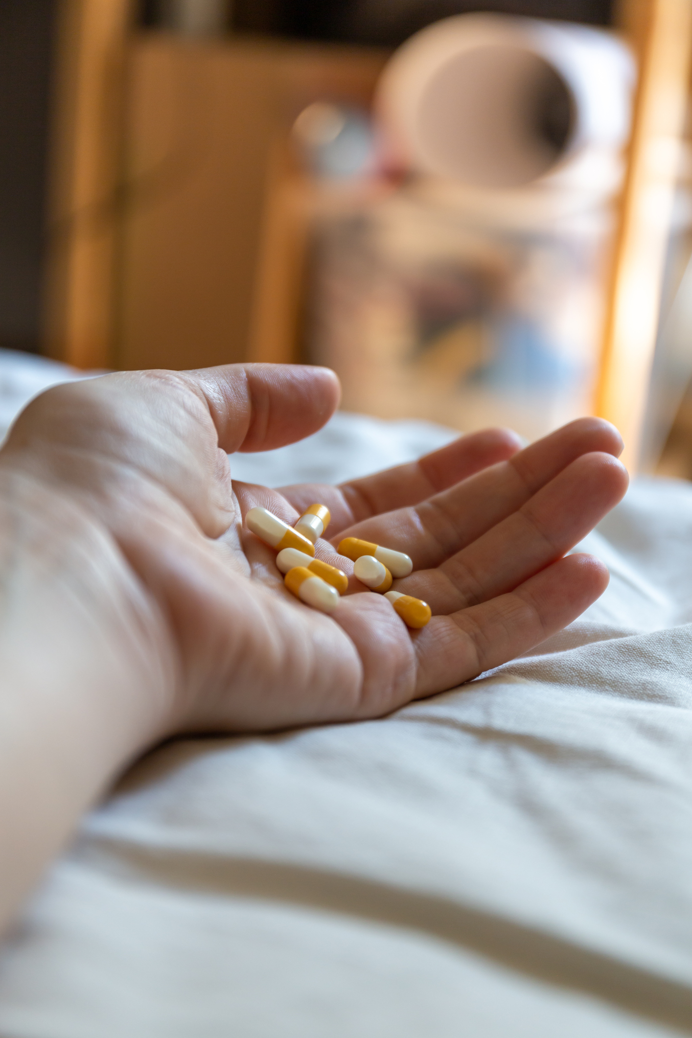 Close up hand of woman overdosing on medication.