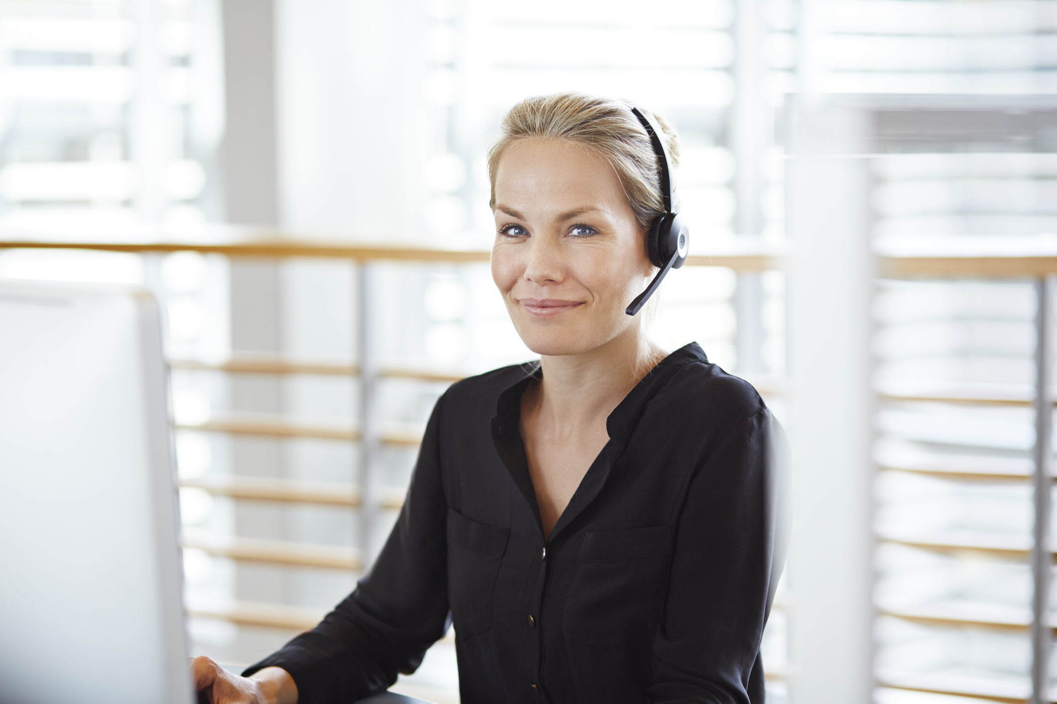 Woman with headset smiling to camera
