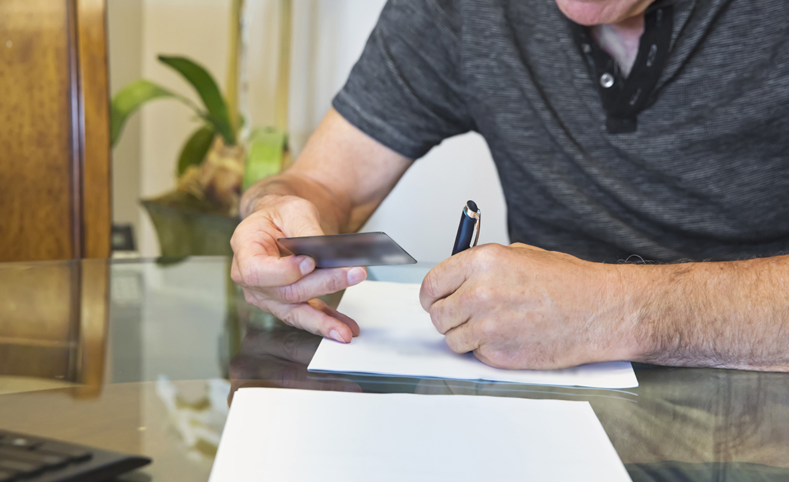 Caucasian senior man at signing of mortgage agreement