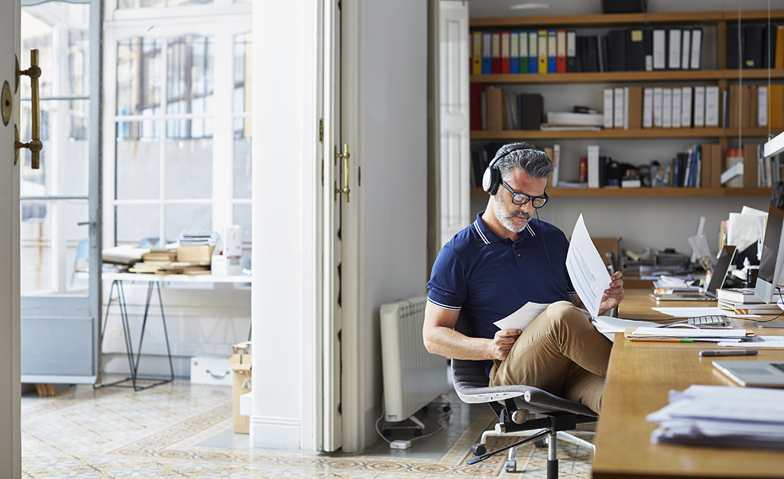 Businessman examining documents at desk