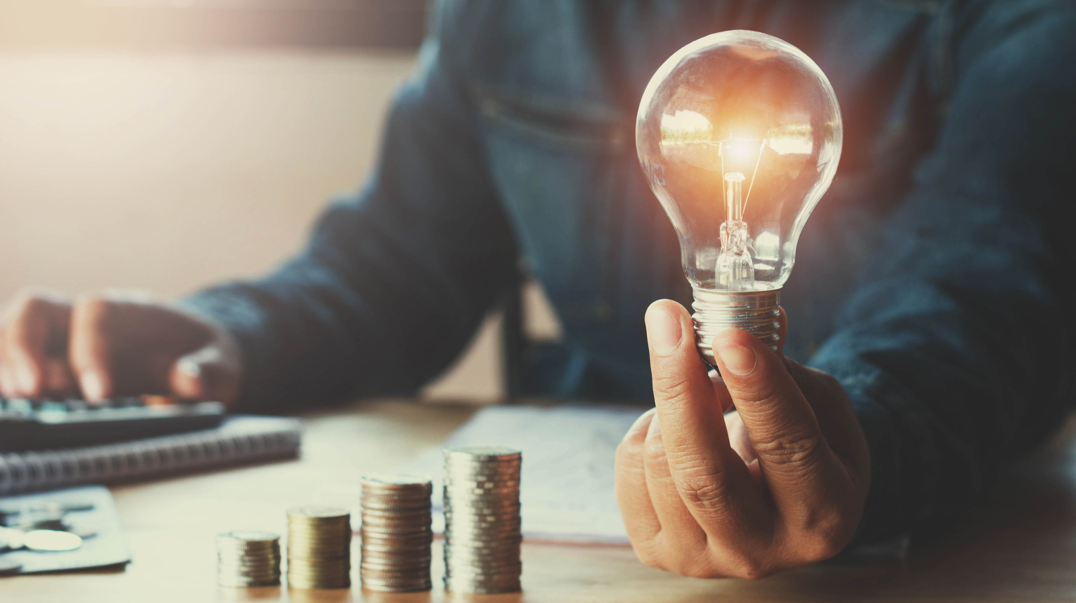 business accountin with saving money with hand holding lightbulb concept financial background