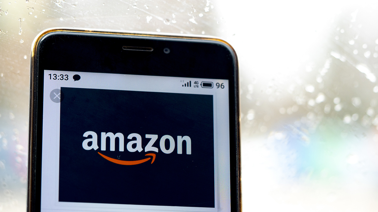 In this photo illustration the Amazon logo is seen displayed