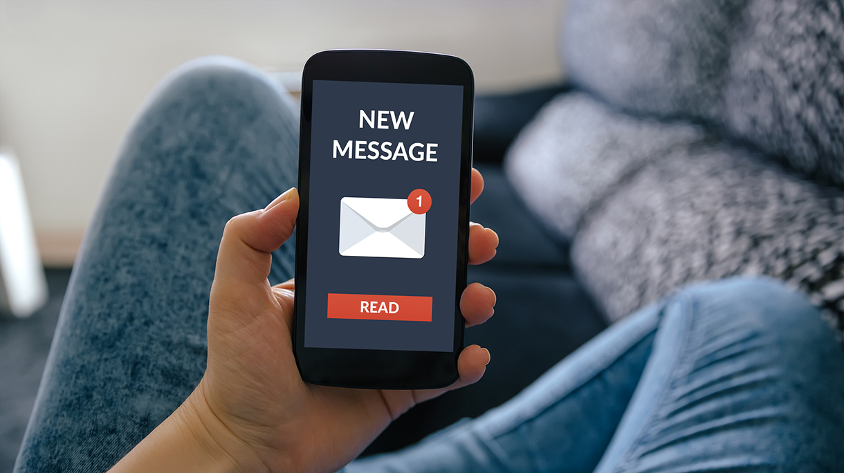 Girl holding smart phone with new message concept on screen