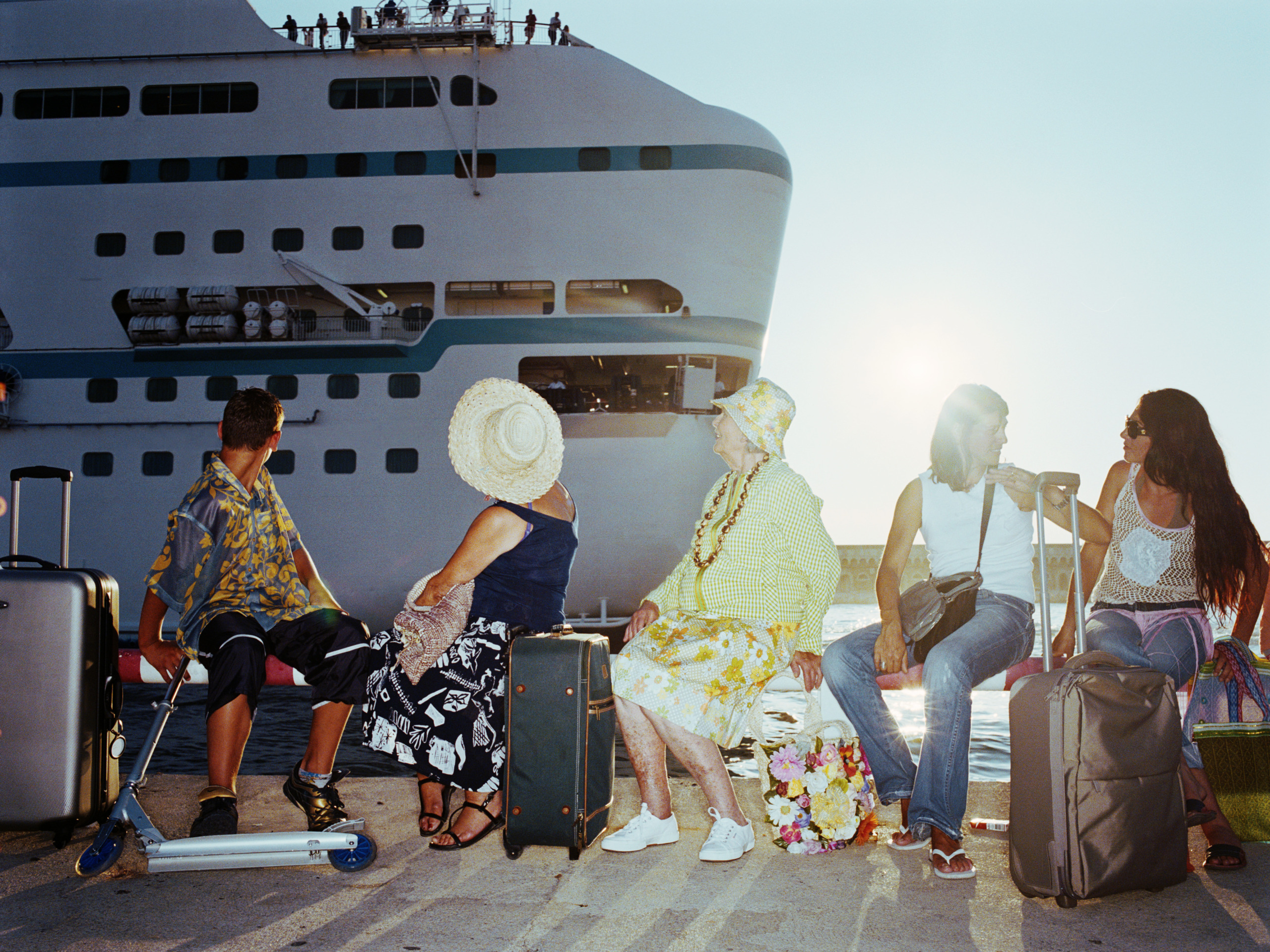 People with luggage waiting to board ship