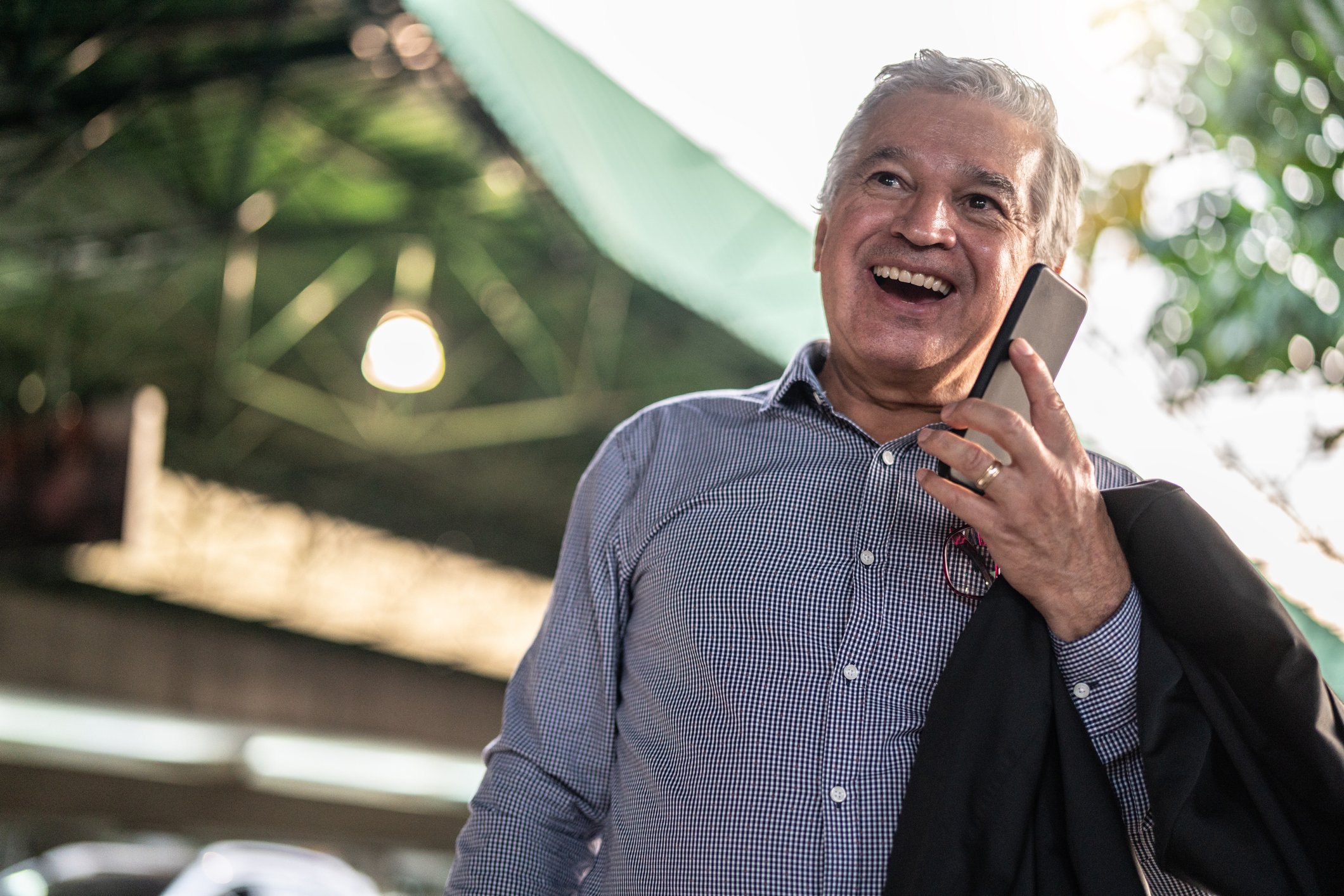 Mature Businessman Using Mobile Phone at Airport