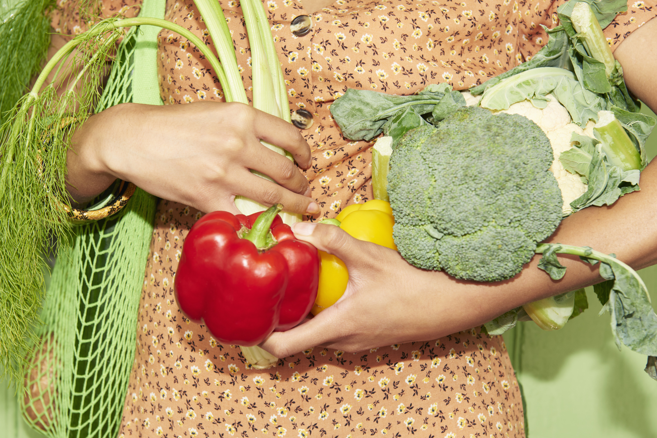 Close up of woman holding vegetables