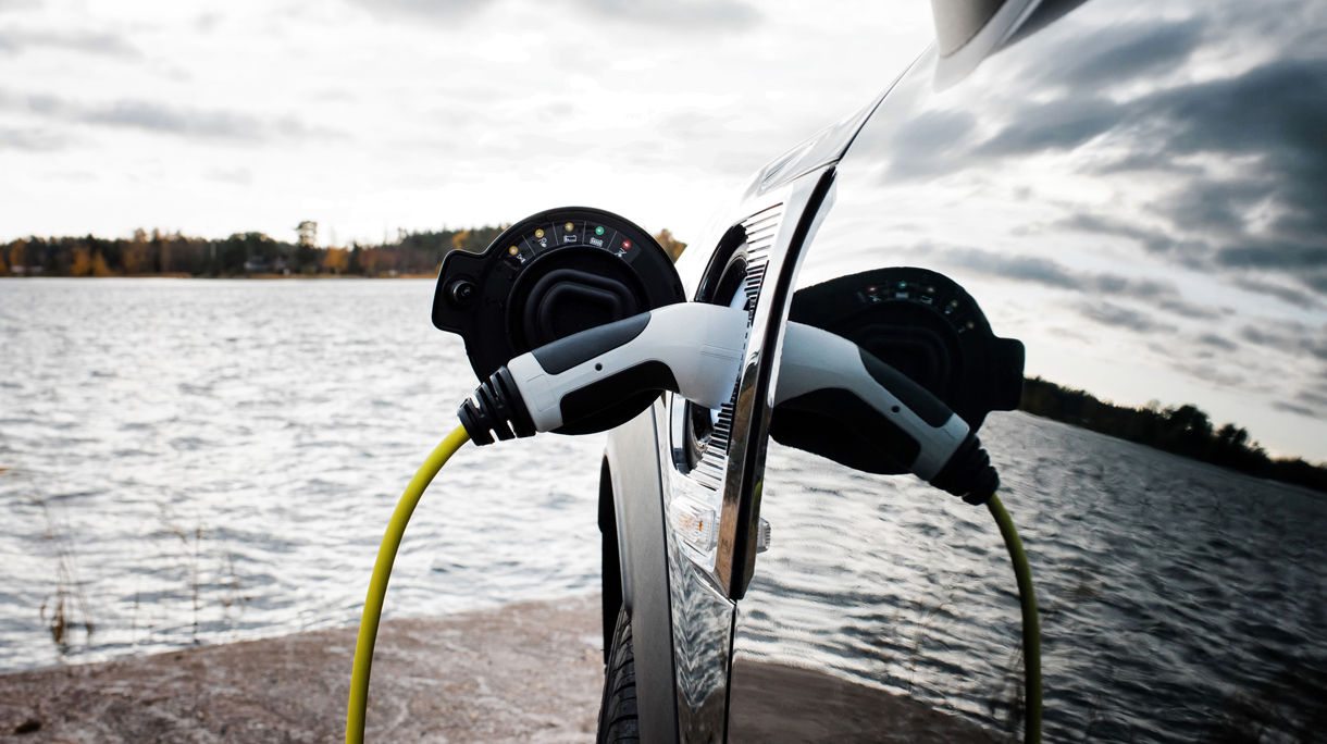 Mini electric car charging socket and lead by the beach