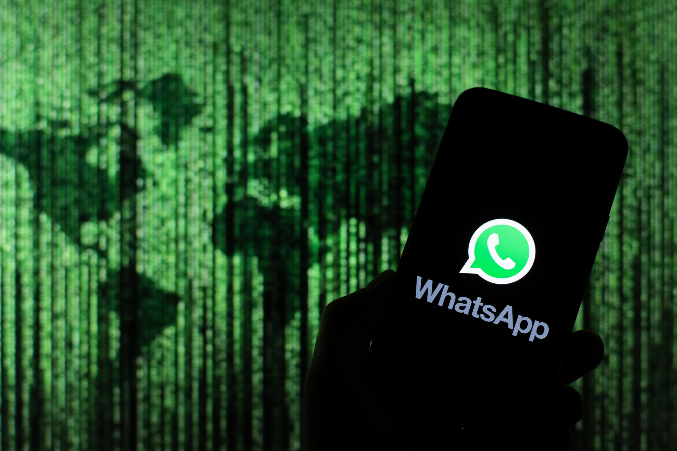 In this photo illustration a WhatsApp messenger app logo