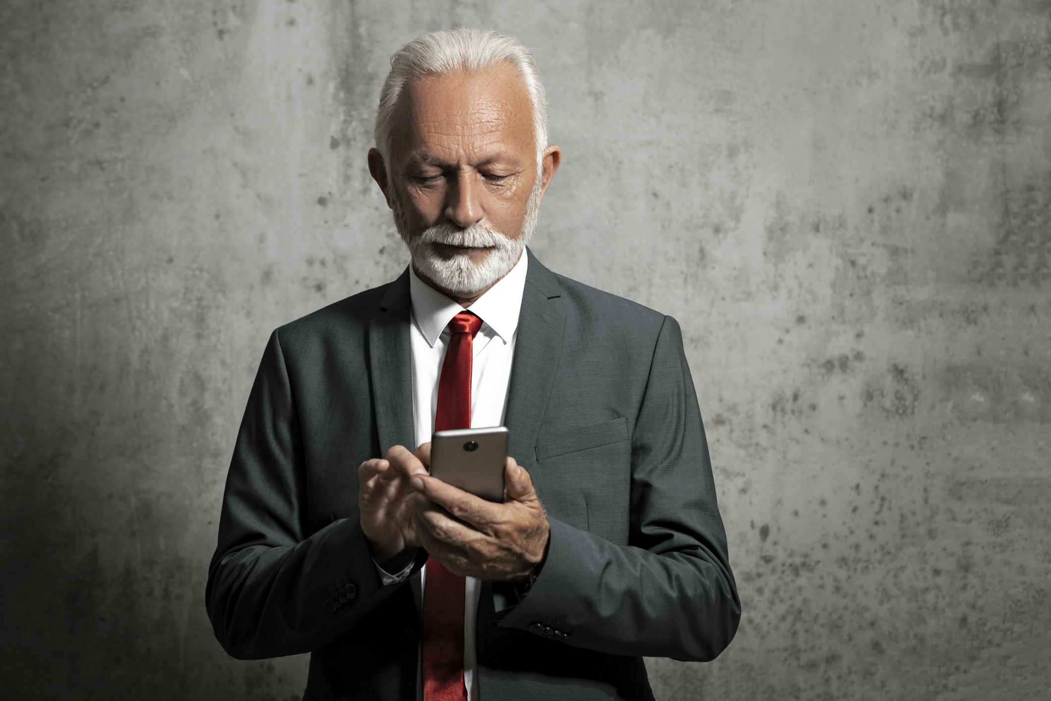 Mature businessman posing with smart phone