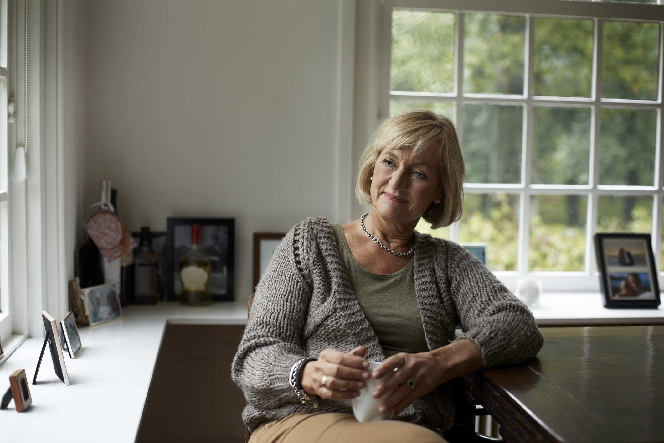 Thoughtful senior woman in cottage
