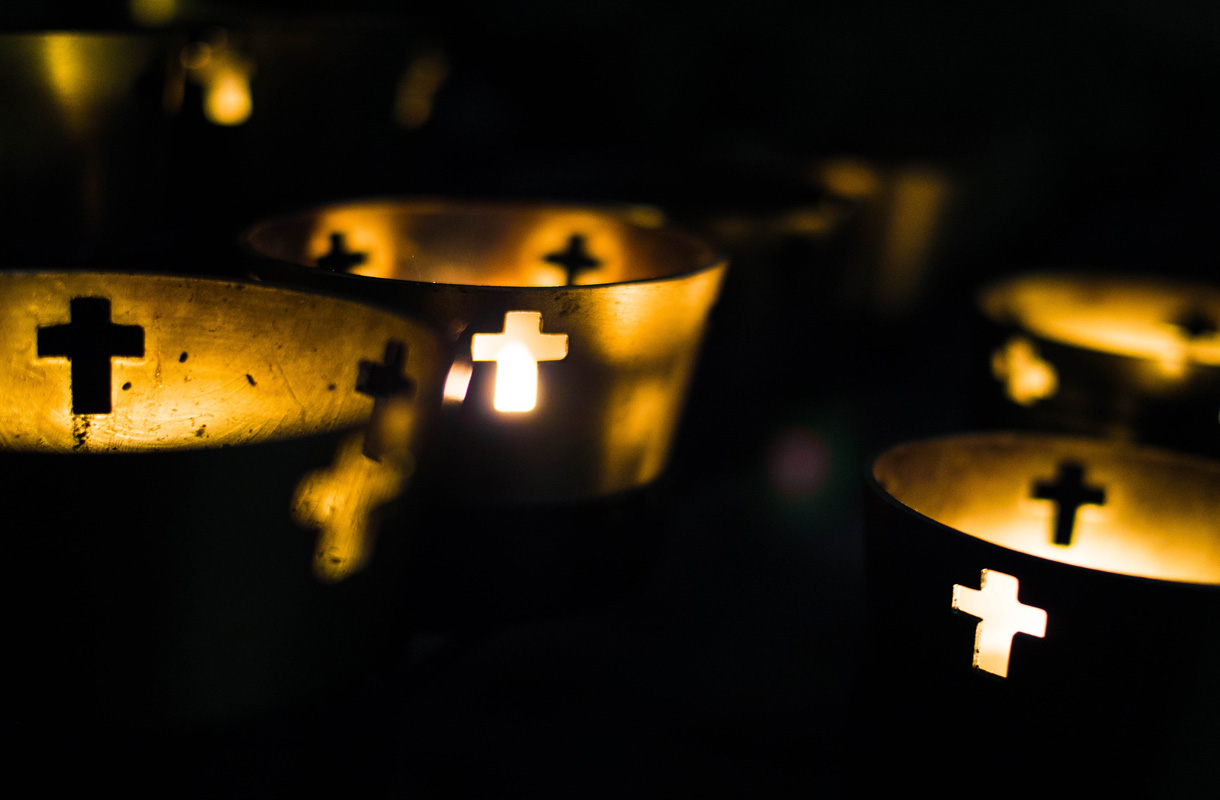 Close-Up Of Illuminated Candles In Church