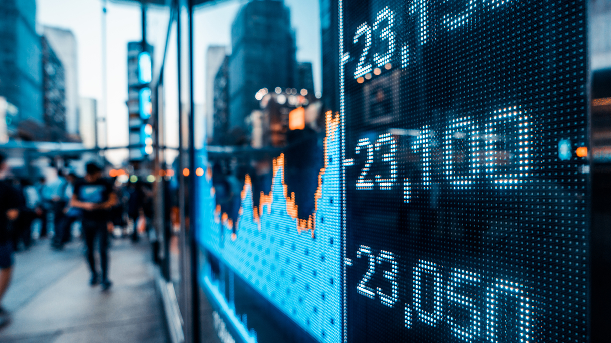 Financial stock market numbers and city light reflection