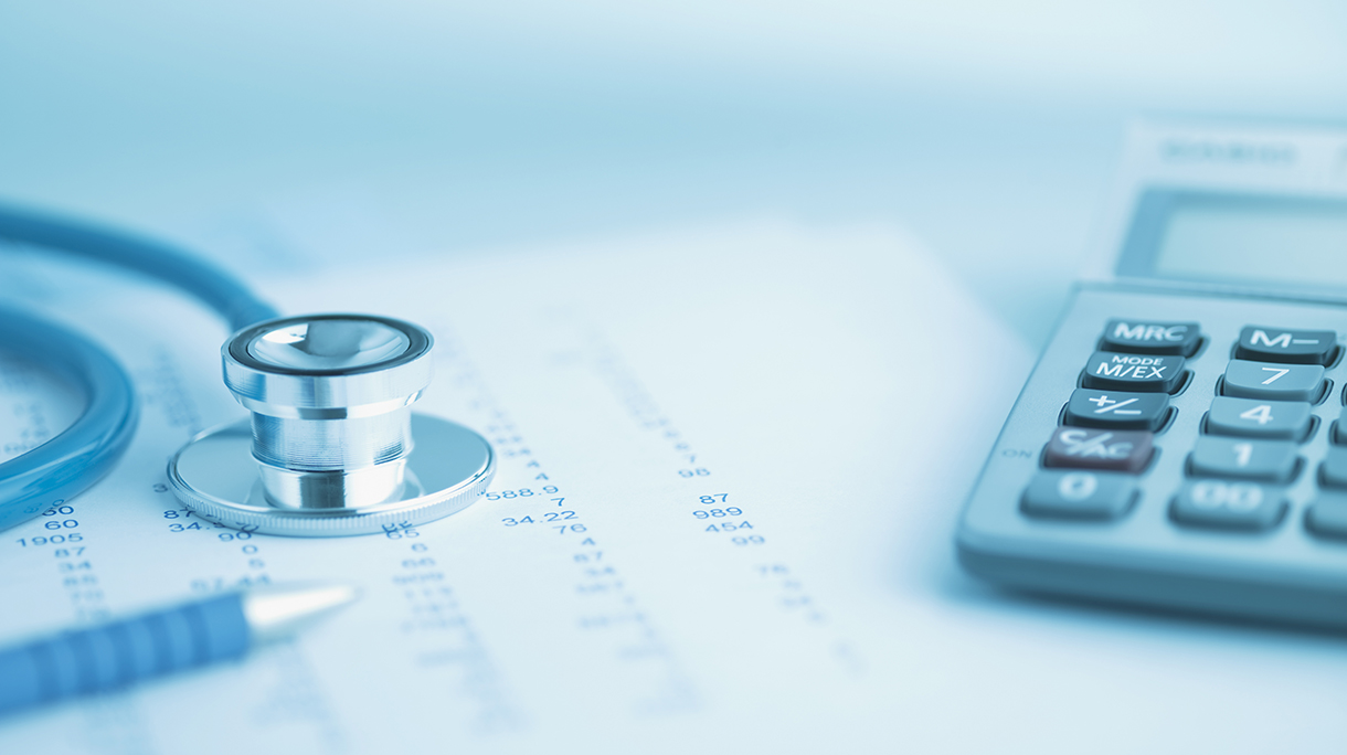 Close up of calculator, data and stethoscope