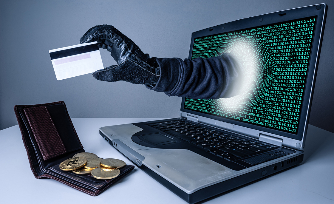 The abstract image of the hacker’s hand reach through a laptop screen for stealing credit card in a wallet. the concept of cyber attack, virus, malware, illegally and cyber security.