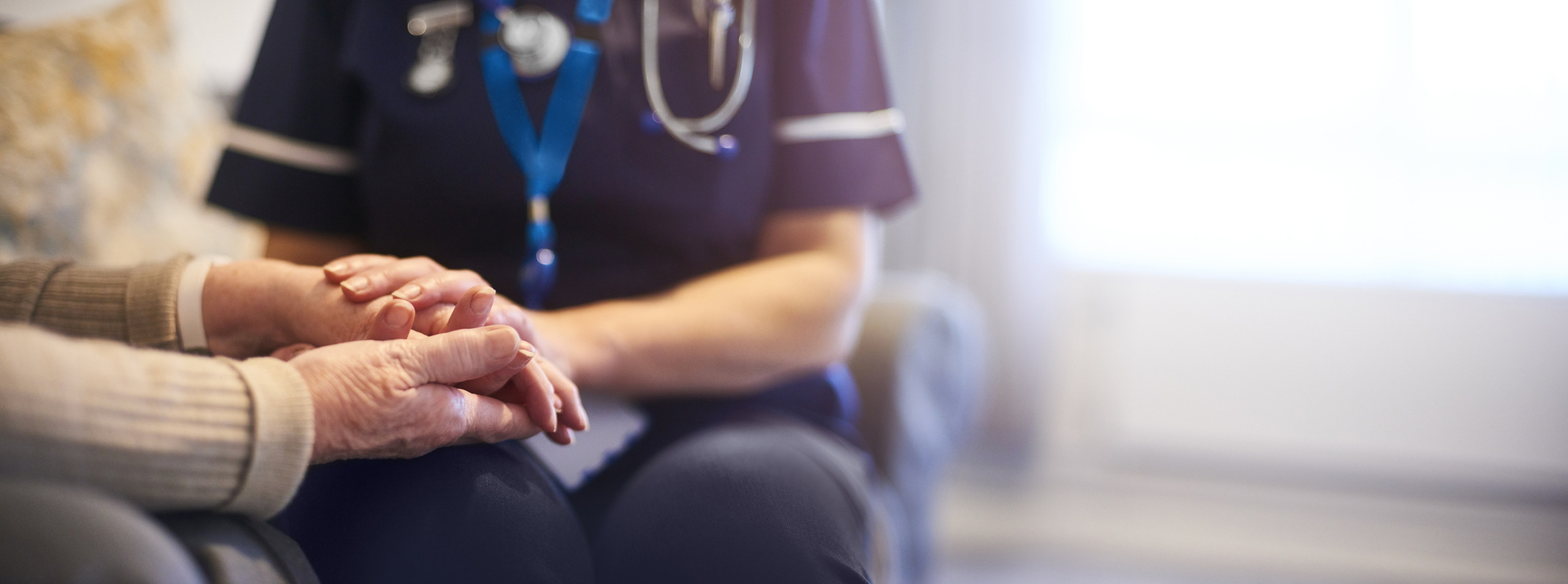 Nurse comforting patient at patient’s home