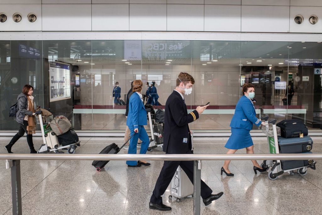 Royal Dutch Airlines (KLM) crew members wearing surgical